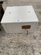 A SMALL METAL SAFE COMPLETE WITH KEY