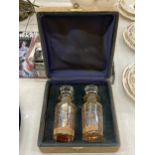 TWO VINTAGE GLASS PERFUME BOTTLES WITH STOPPERS IN THE ORIGINAL CASE