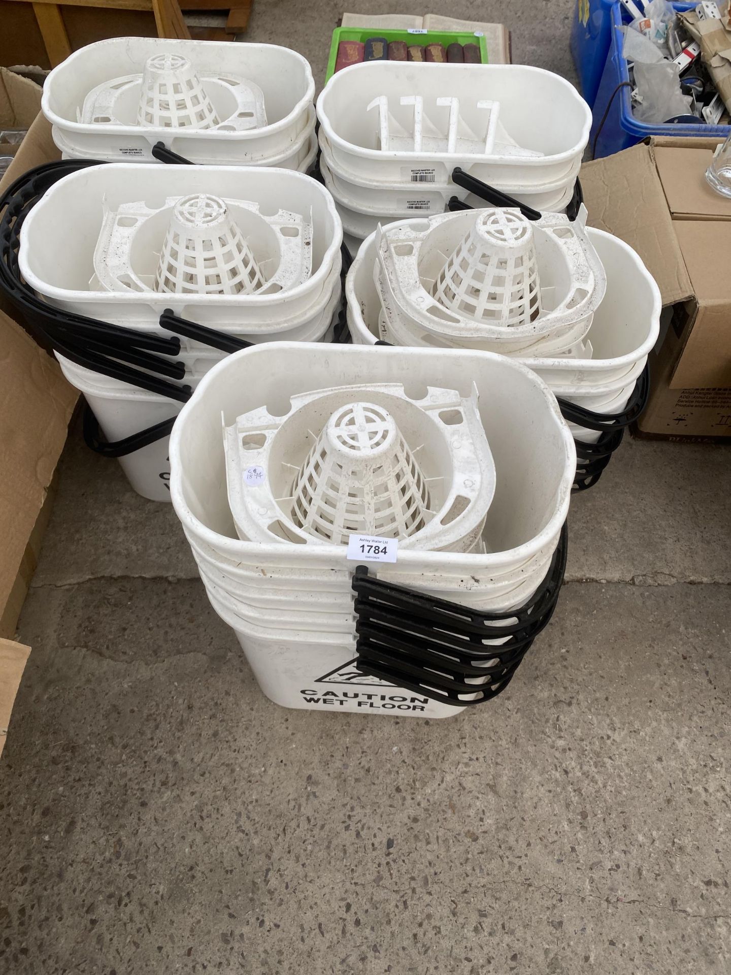 A LARGE QUANTITY OF PLASTIC MOP BUCKETS WITH WET FLOOR WARNINGS