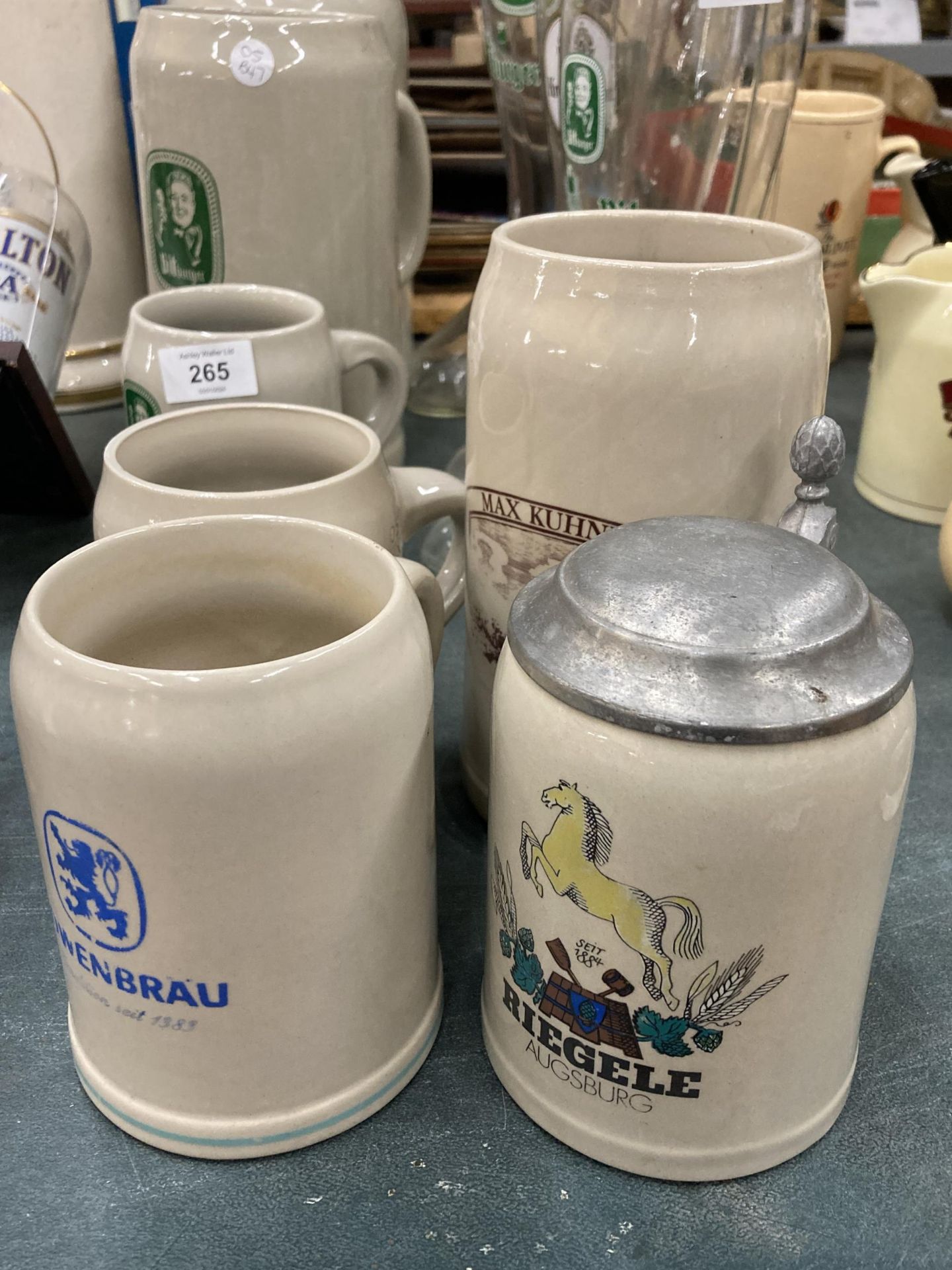 FOUR STONEWARE STEINS TO INCLUDE KUNHLE, DAB, RIEGELE AND LOWENBRAU