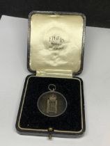 A BOXED SILVER MEDAL