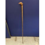 A TALL HIKING STAFF WITH A CARVED PHEASANT DESIGN HANDLE