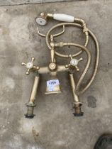 A VINTAGE BRASS MIXER TAP AND SHOWER HEAD