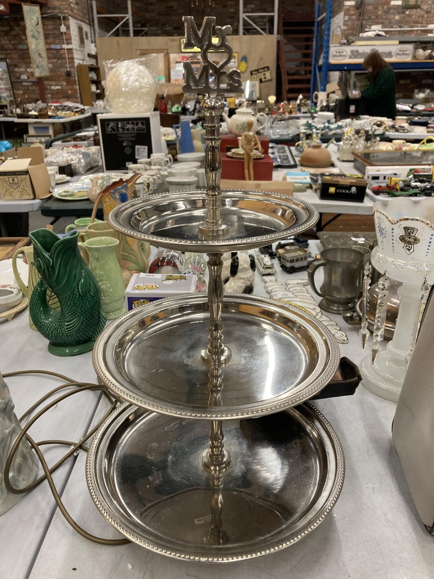 A SILVER PLATED 'MR AND MRS, THREE TIER CAKE STAND, HEIGHT APPROX 52CM