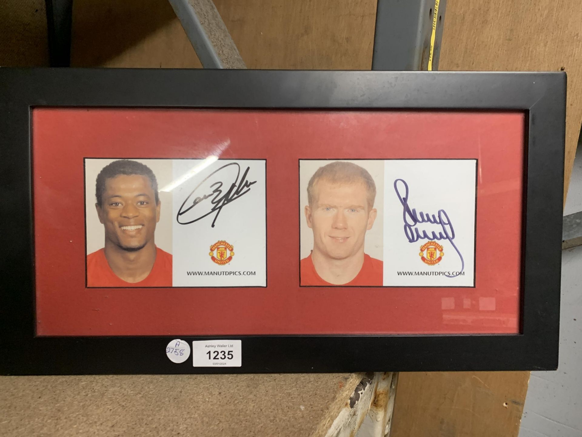 A FRAMED MANCHESTER UNITED SIGNED PICTURE - PATRICE EVRA AND PAUL SCHOLES