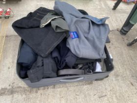 A SUITCASE CONTAINING AN ASSORTMENT OF CLOTHING