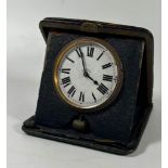 A VINTAGE LEATHER CASED 8 DAY TRAVEL POCKET CLOCK