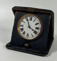 A VINTAGE LEATHER CASED 8 DAY TRAVEL POCKET CLOCK