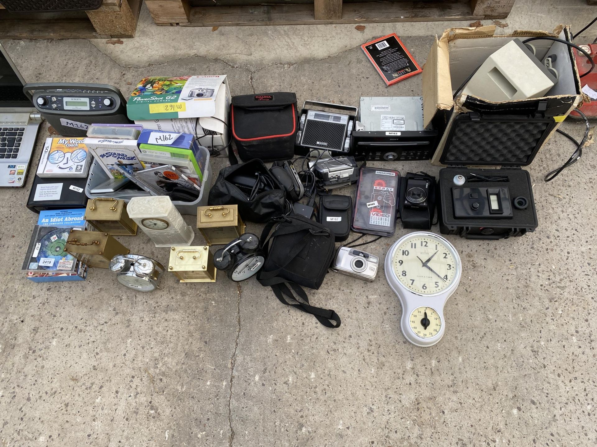 A LARGE ASSORTMENT OF ITEMS TO INCLUDE CLOCKS, RADIOS AND CAMERAS ETC