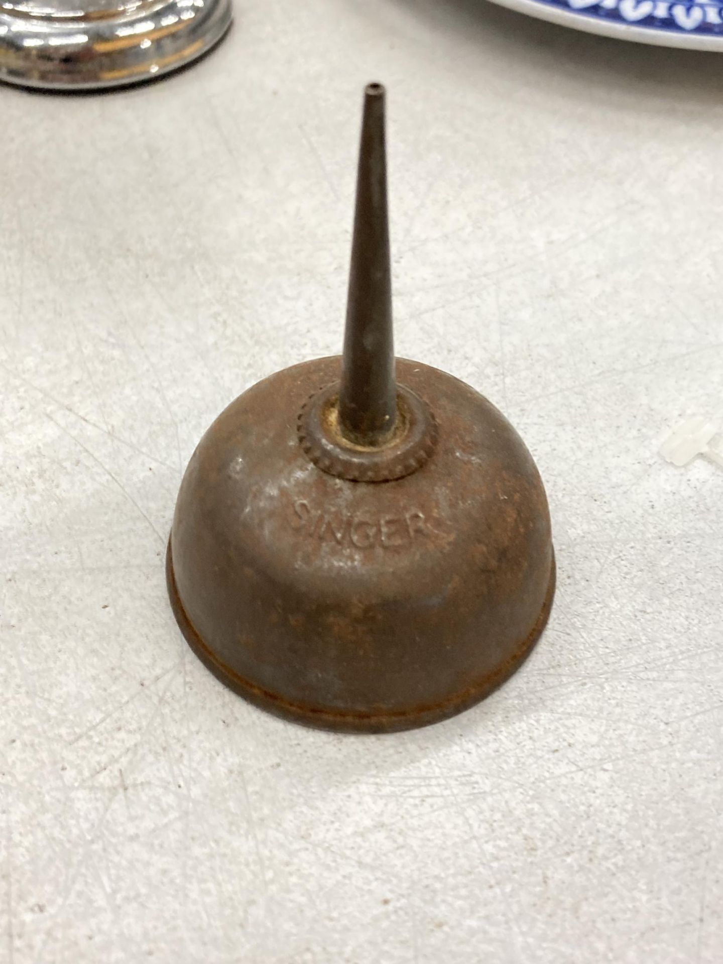 A VINTAGE SINGER METAL OIL CAN