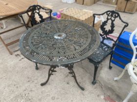 A VINTAGE STYLE ALLOY BISTRO SET COMPRISING OF A ROUND TABLE AND TWO CHAIRS