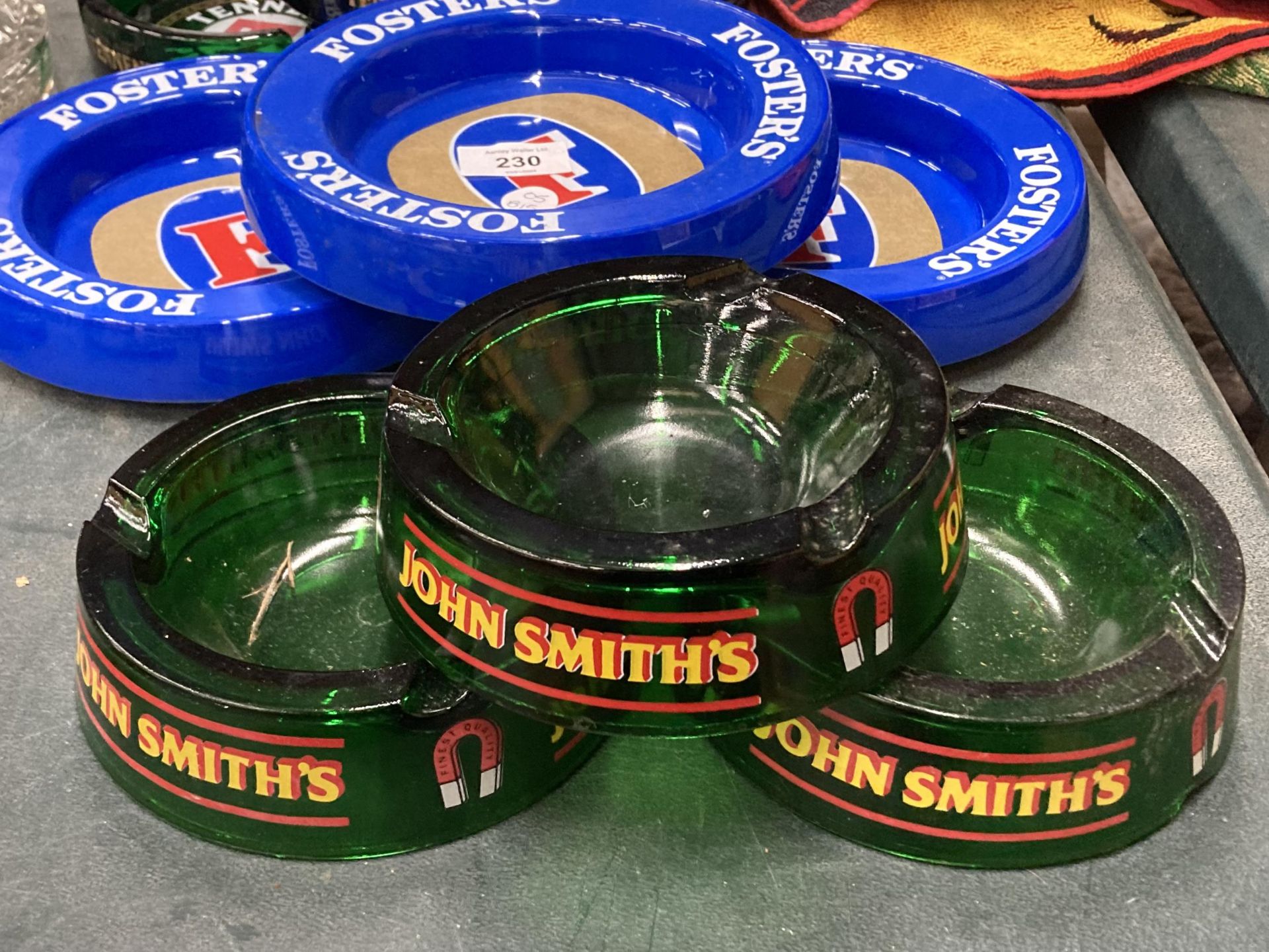 THREE JOHN SMITH'S GLASS ASHTRAYS