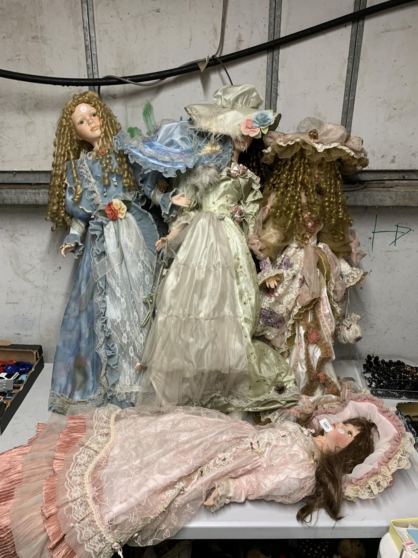 A GROUP OF LARGE PORCELAIN HEADED DOLLS