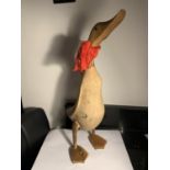 A LARGE WOODEN DUCK FIGURE WITH A RED SCARF