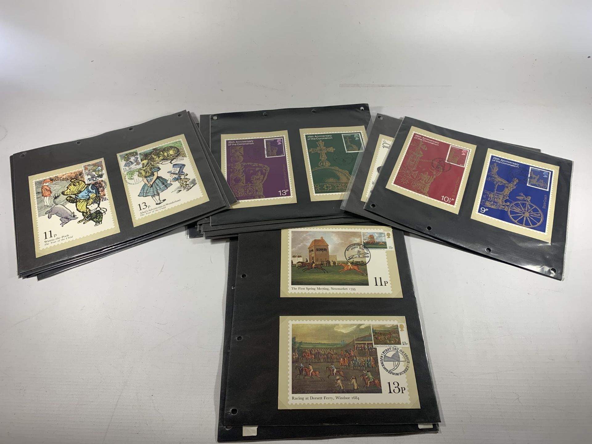 A QUANTITY OF STAMP POSTCARDS TO INCLUDE WINNIE THE POOH, ALICE'S ADVENTURE IN WONDERLAND, 25TH