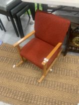 A RETRO CHILDS ROCKING CHAIR WITH RED UPHOLSTERY