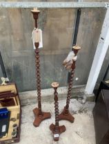 A SET OF THREE GRADUATED BOBBIN TURNED HAT STANDS