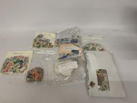 EIGHT BAGS OF LOOSE STAMPS TO INCLUDE FRANCE, BAILWICK OF GUERNSEY, ISLE OF MAN, AFRICA, ETC.,