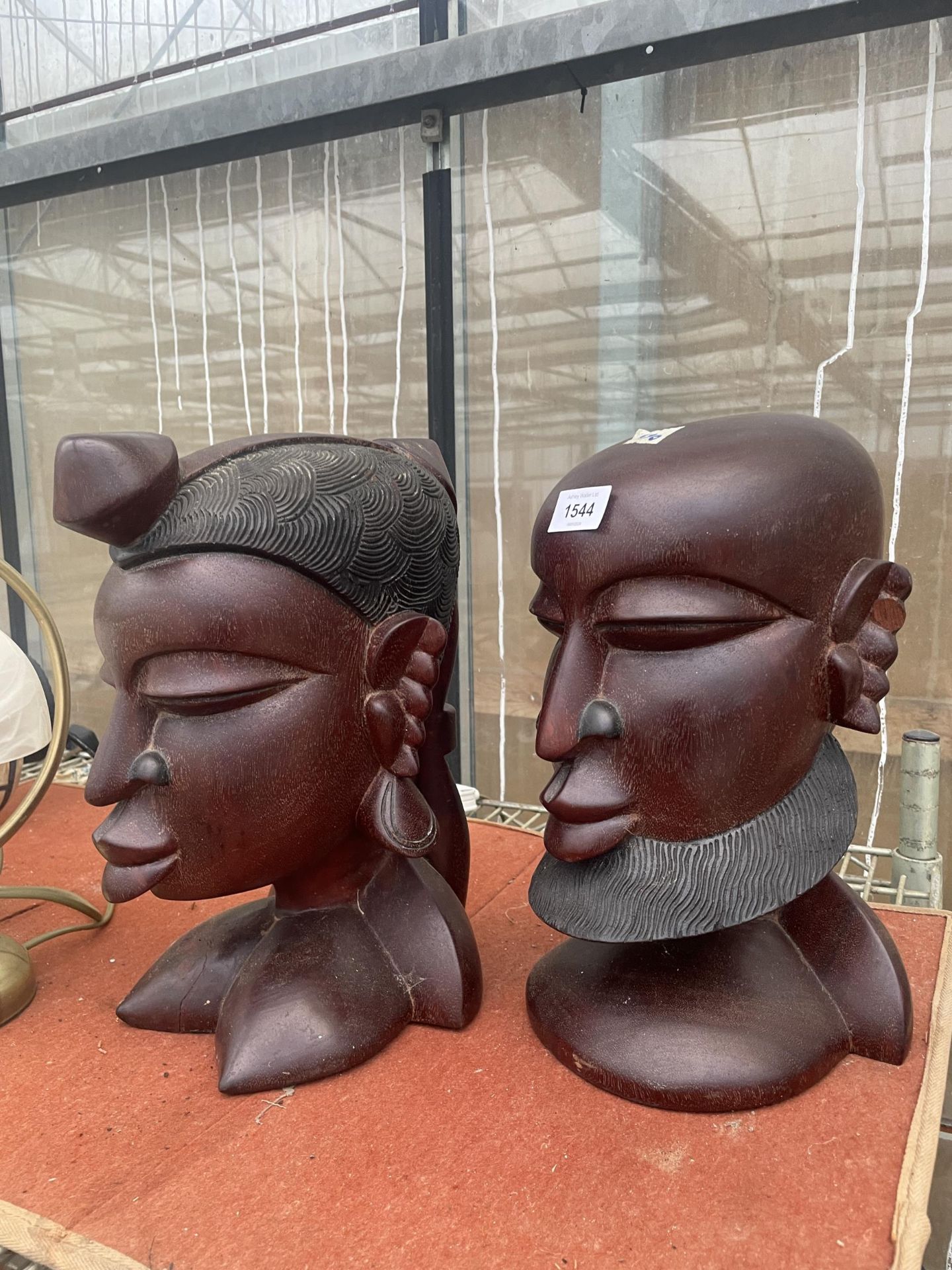 TWO VINTAGE HEAVY WOODEN TRIBAL BUSTS
