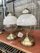 A PAIR OF BRASS EFFECT TABLE LAMPS WITH GLASS SHADES