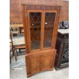 A REPRODUCTION OAK CORNER CUPBOARD WITH GLAZED AND LEADED UPPER PORTION, 30" WIDE