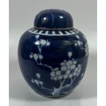 A CHINESE PRUNUS BLOSSOM GINGER JAR WITH DOUBLE RING MARK TO BASE, ON CARVED WOODEN STAND, HEIGHT 18