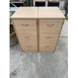 A PAIR OF THREE DRAWER WOODEN FILING CABINETS, BOTH WITH A KEY