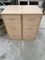 A PAIR OF THREE DRAWER WOODEN FILING CABINETS, BOTH WITH A KEY
