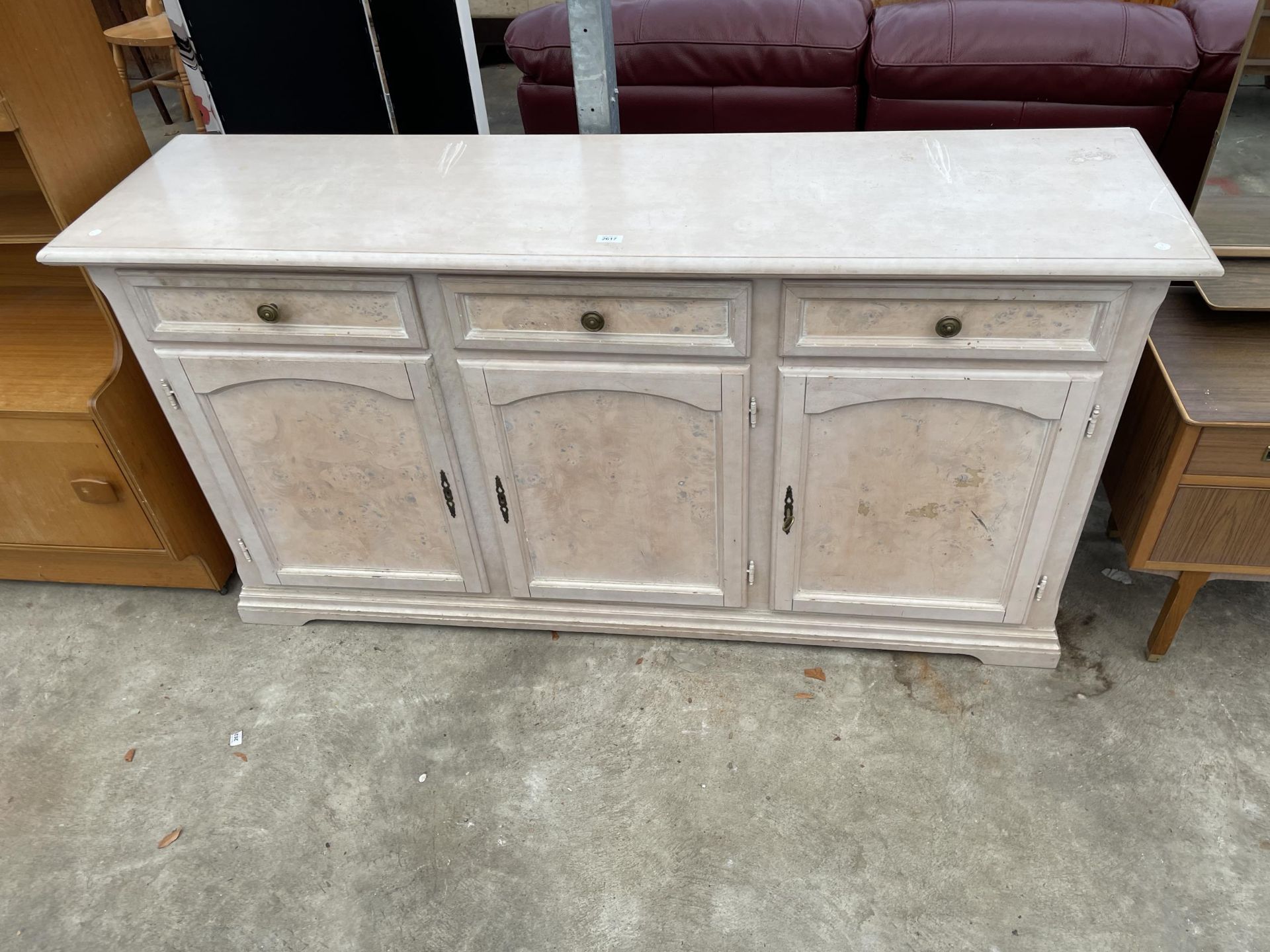 A MODERN PAINTED SIDEBOARD ENCLOSING THREE DRAWERS AND THREE CUPBOARDS, 67" WIDE