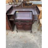 A MAHOGANY ARTS & CRAFTS BUREAU WITH GALLERY BACK WITH SPINDLE UPRIGHTS, FALL FRONT WITH DRAWERS AND