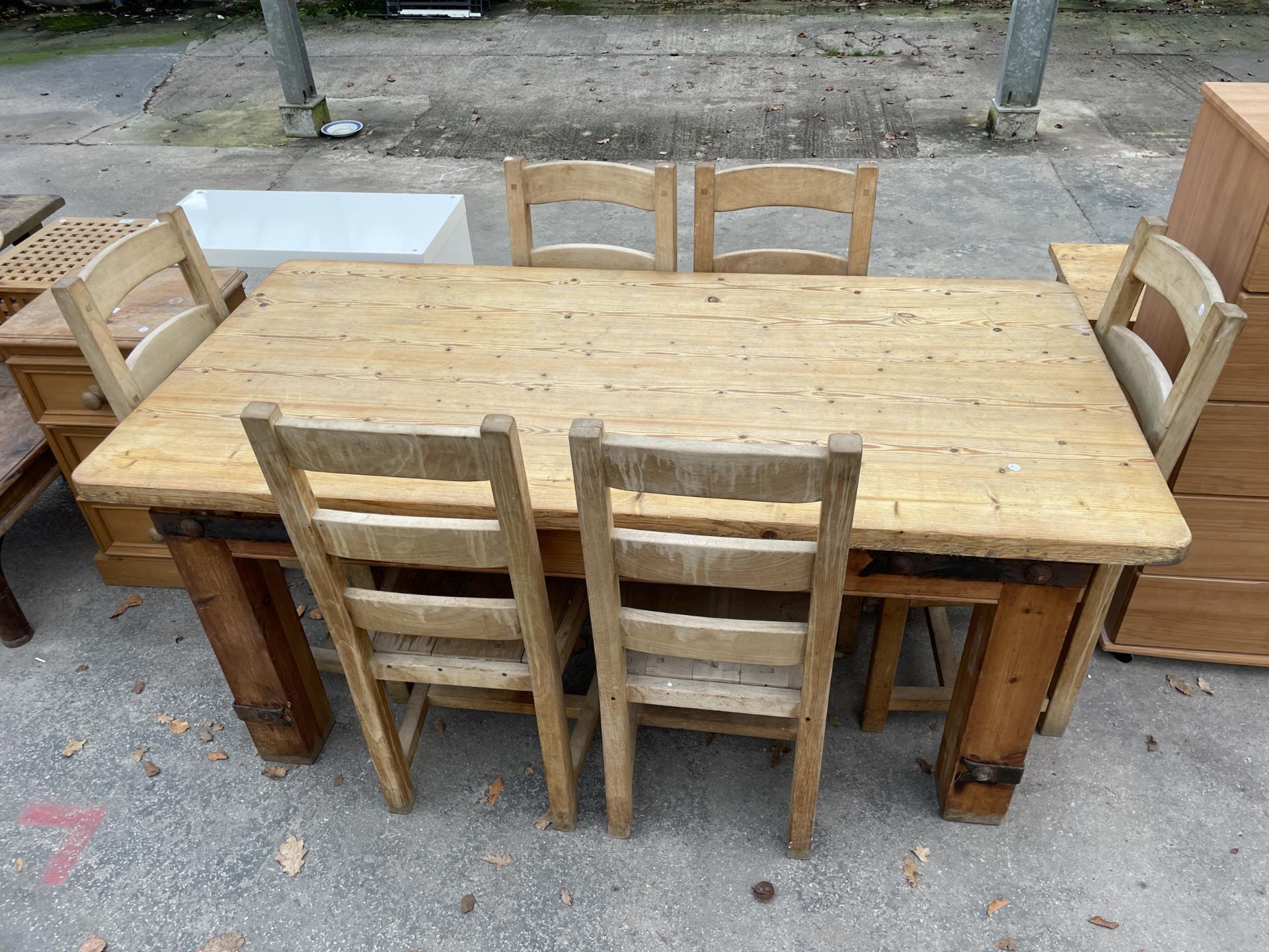 A PINE DINING TABLE, 72 X 35" WITH METAL STRAPS AND SIX CHAIRS