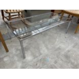 A POLISHED CHROME AND GLASS COFFEE TABLE, 48 X 24"