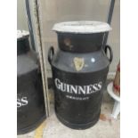 A DECORATIVE METAL MILK CHURN WITH LID AND GUINNESS DETAILING