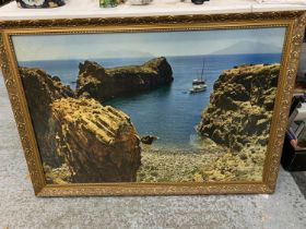 A LARGE FRAMED PRINT OF BOATS NEAR A BEACH