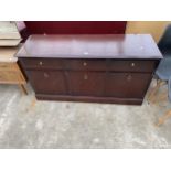 A STAG MINSTREL SIDEBOARD ENCLOSING THREE DRAWERS AND THREE CUPBOARDS, 54" WIDE