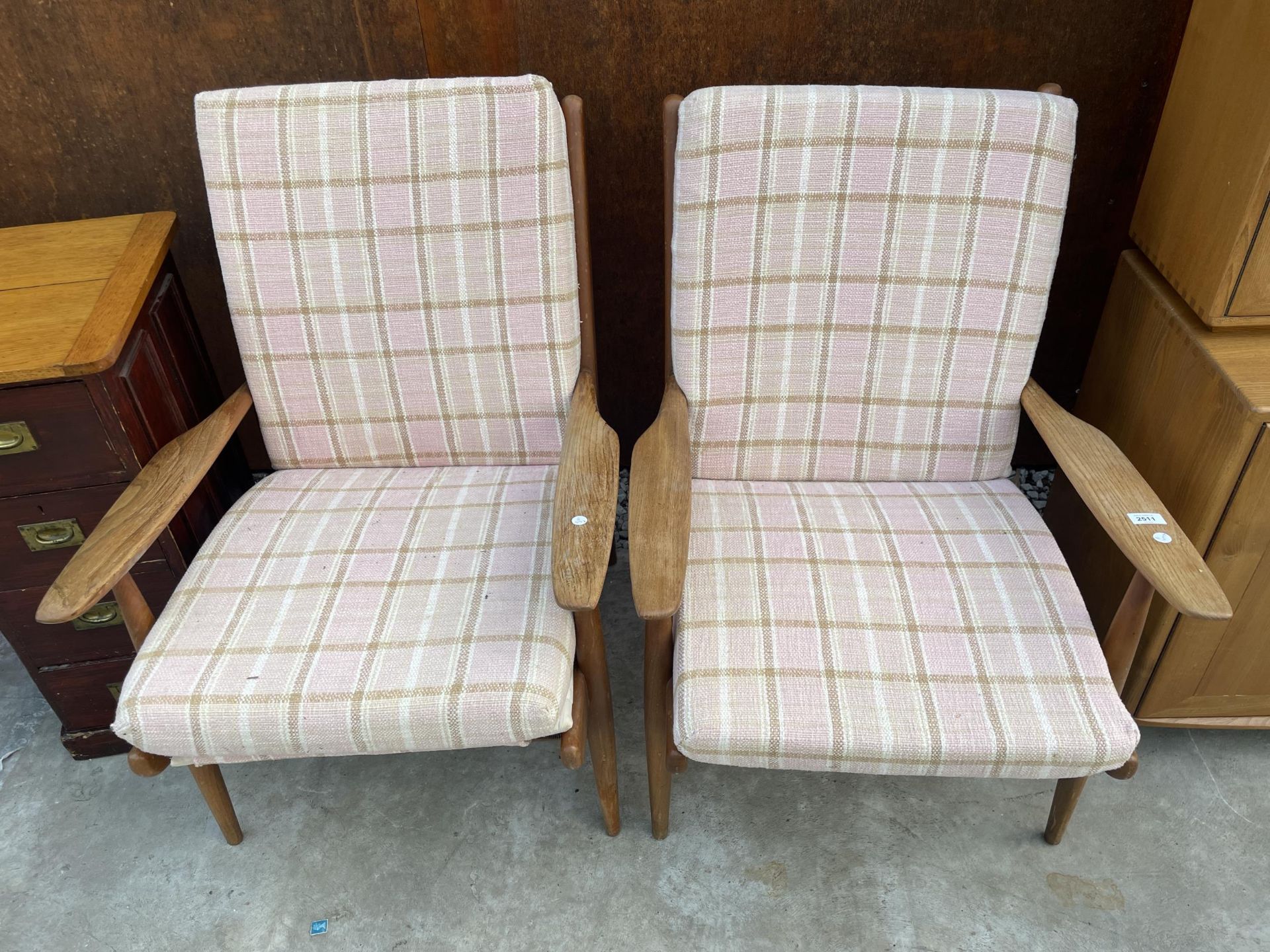 A PAIR OF RETRO ELM AND TEAK FIRESIDE CHAIRS