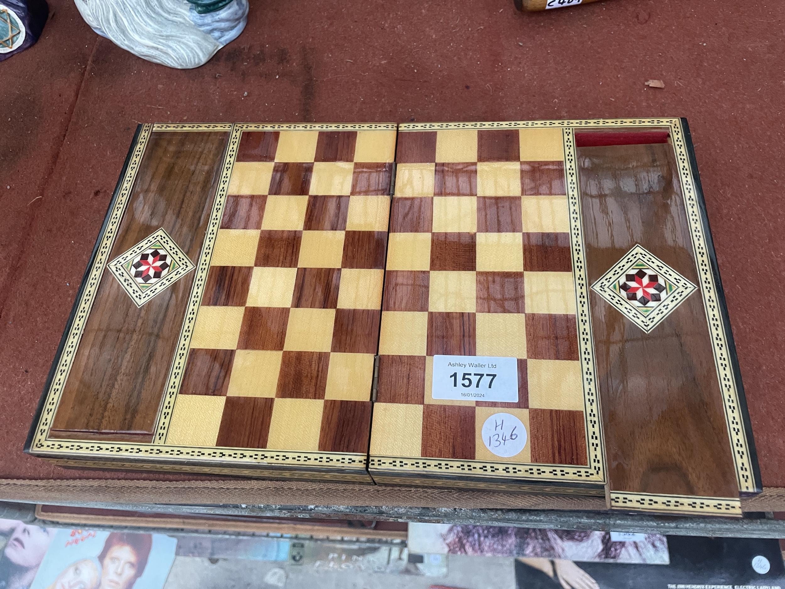 A VINTAGE WOODEN FOLDING TRAVEL CHESS BOARD AND CHESS PIECES