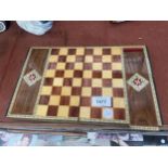 A VINTAGE WOODEN FOLDING TRAVEL CHESS BOARD AND CHESS PIECES