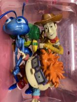 THREE FIGURES TO INCLUDE A BUG'S LIFE, WOODY FROM TOY STORY AND RUGRATS