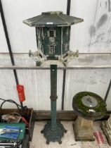 A DECORATIVE CAST METAL BIRD FEEDER