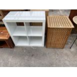 A LAUNDRY BASKET ENCLOSED IN LATTICE WORK FRAME AND WHITE FOUR DIVISION OPEN SHELVES