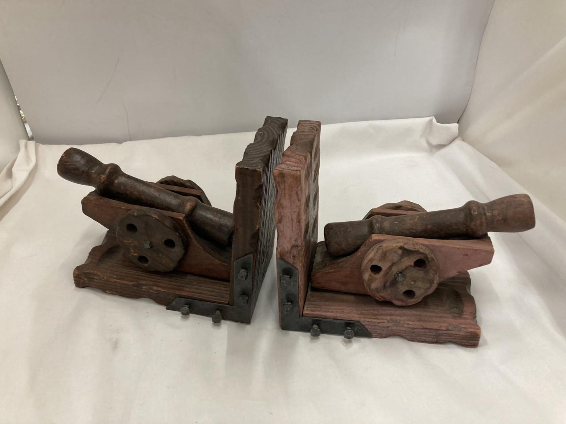 A PAIR OF WOODEN CANON BOOK-ENDS