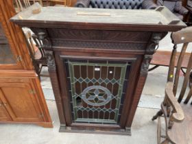 A VICTORIAN GOTHIC OAK CABINET WITH COLOURED GLASS AND LEADED DOOR, 38" WIDE