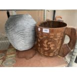 A LARGE DECORATIVE WOODEN CARVED CUP AND A CONCRETE PLANTER