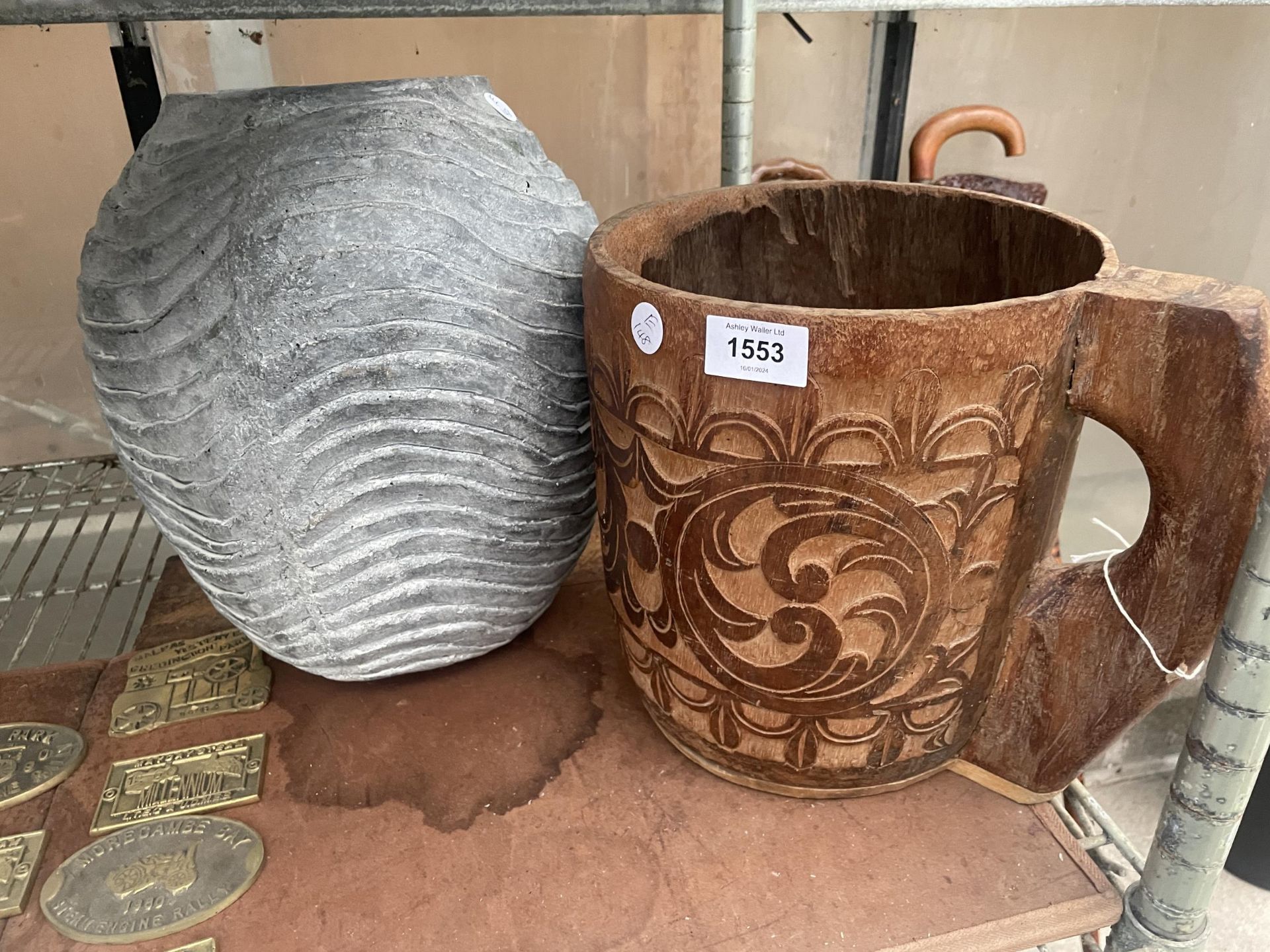 A LARGE DECORATIVE WOODEN CARVED CUP AND A CONCRETE PLANTER