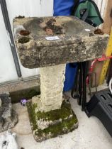 A DECORATIVE CONCRETE BIRDBATH WITH PEDESTAL BASE