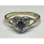 A 9 CARAT GOLD RING WITH A CENTRE SAPPHIRE SURROUNDED BY DIAMONDS IN A HEART SHAPE SIZE M