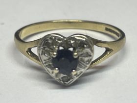 A 9 CARAT GOLD RING WITH A CENTRE SAPPHIRE SURROUNDED BY DIAMONDS IN A HEART SHAPE SIZE M