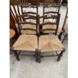 A SET OF FOUR OAK LADDERBACK DINING CHAIRS WITH RUSH SEATS