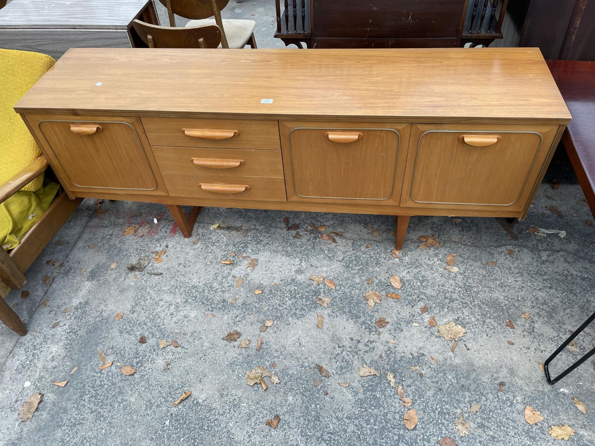 A RETRO TEAK SIDEBOARD ENCLOSING THREE DRAWERS, TWO CUPBOARDS AND DROP-DOWN COCKTAIL SECTION, 72"